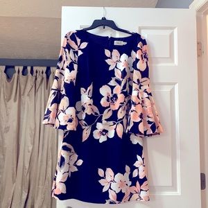 A business causal dress navy blue with coral flowers.